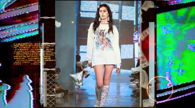 a woman walking down a runway in a white dress