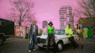 a group of people standing next to a white truck