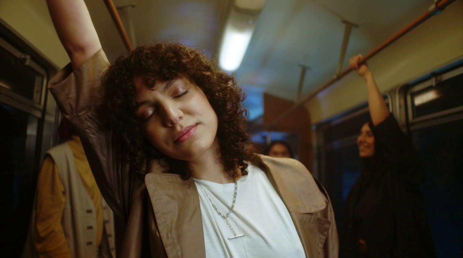 a woman with her eyes closed on a train