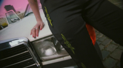 a close up of a person standing next to a car