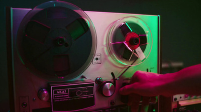 a person operating a turntable with a green light