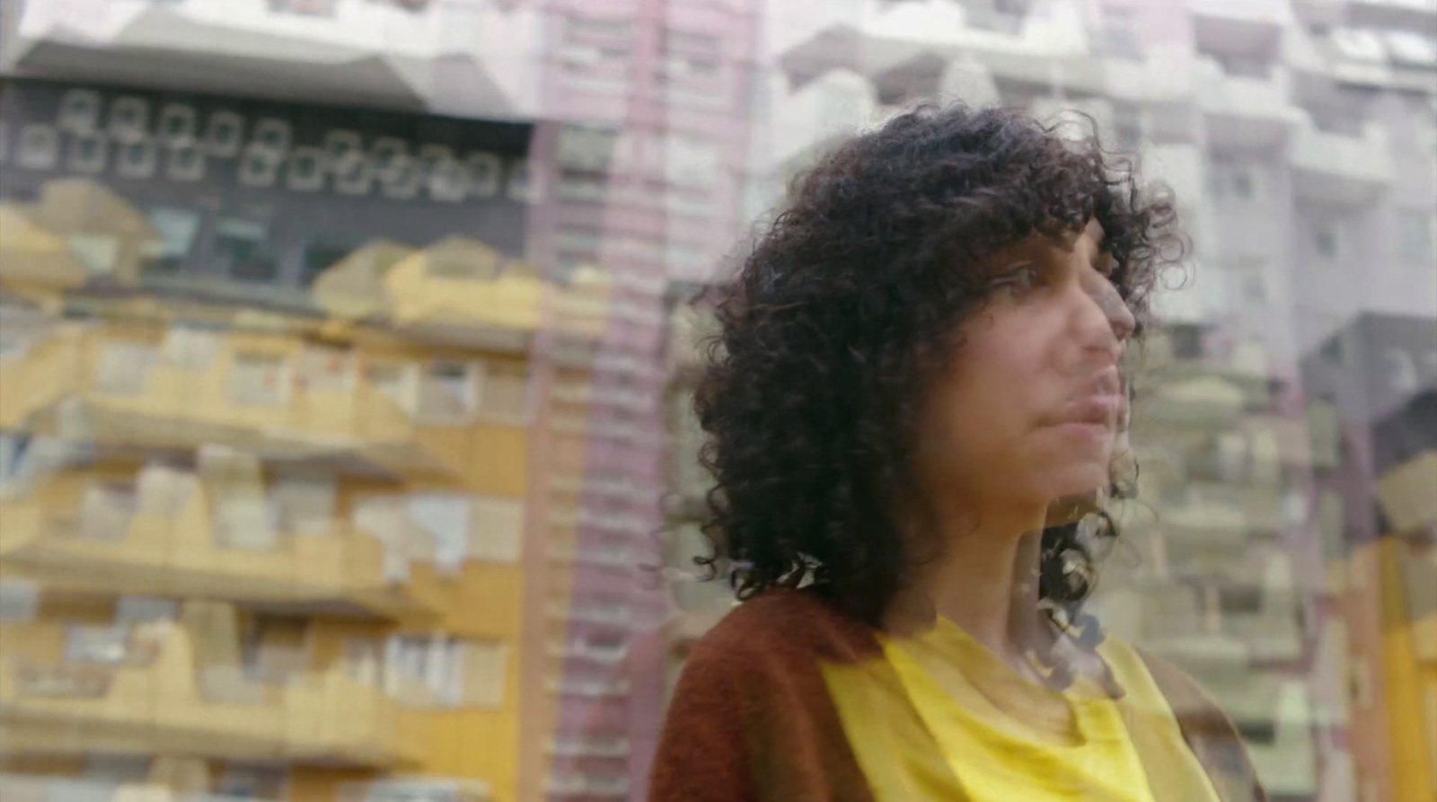 a woman standing in front of a tall building