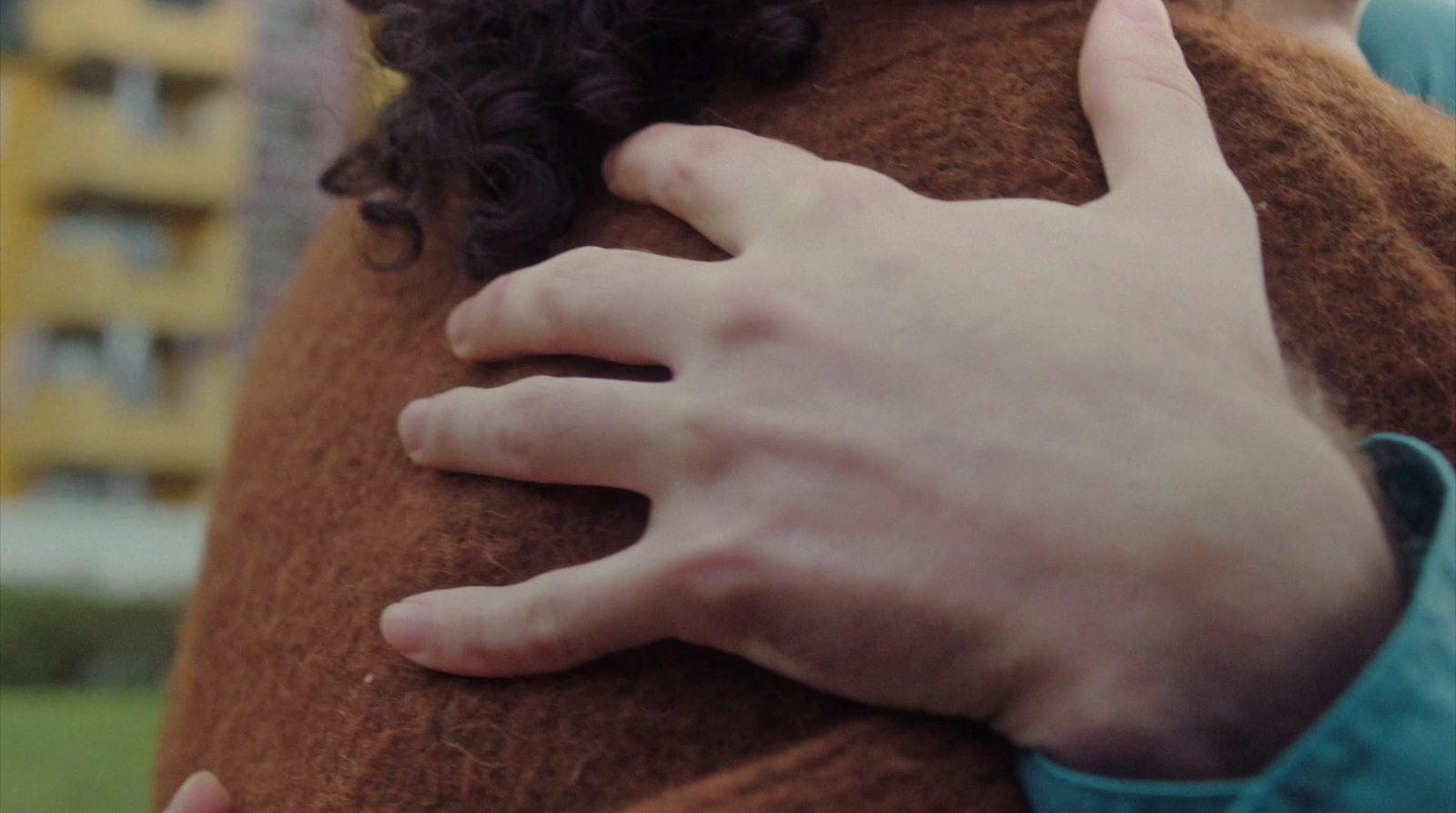 a close up of a person holding a stuffed animal