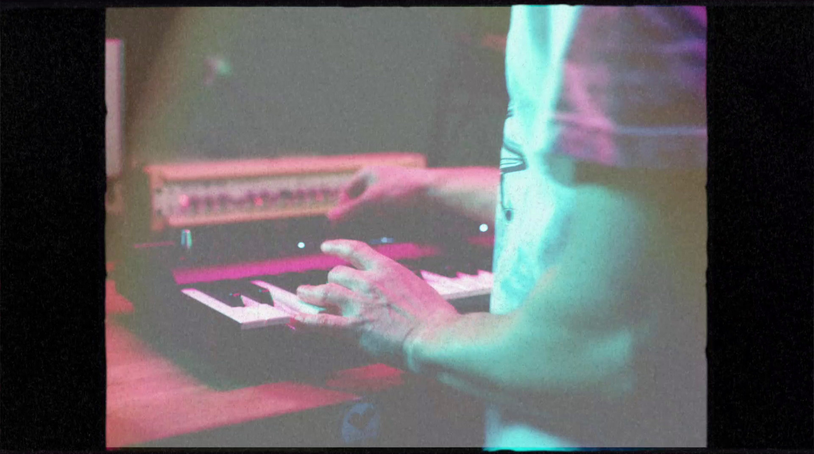 a person playing a keyboard with a blurry background