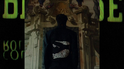 a man standing in front of a clock tower