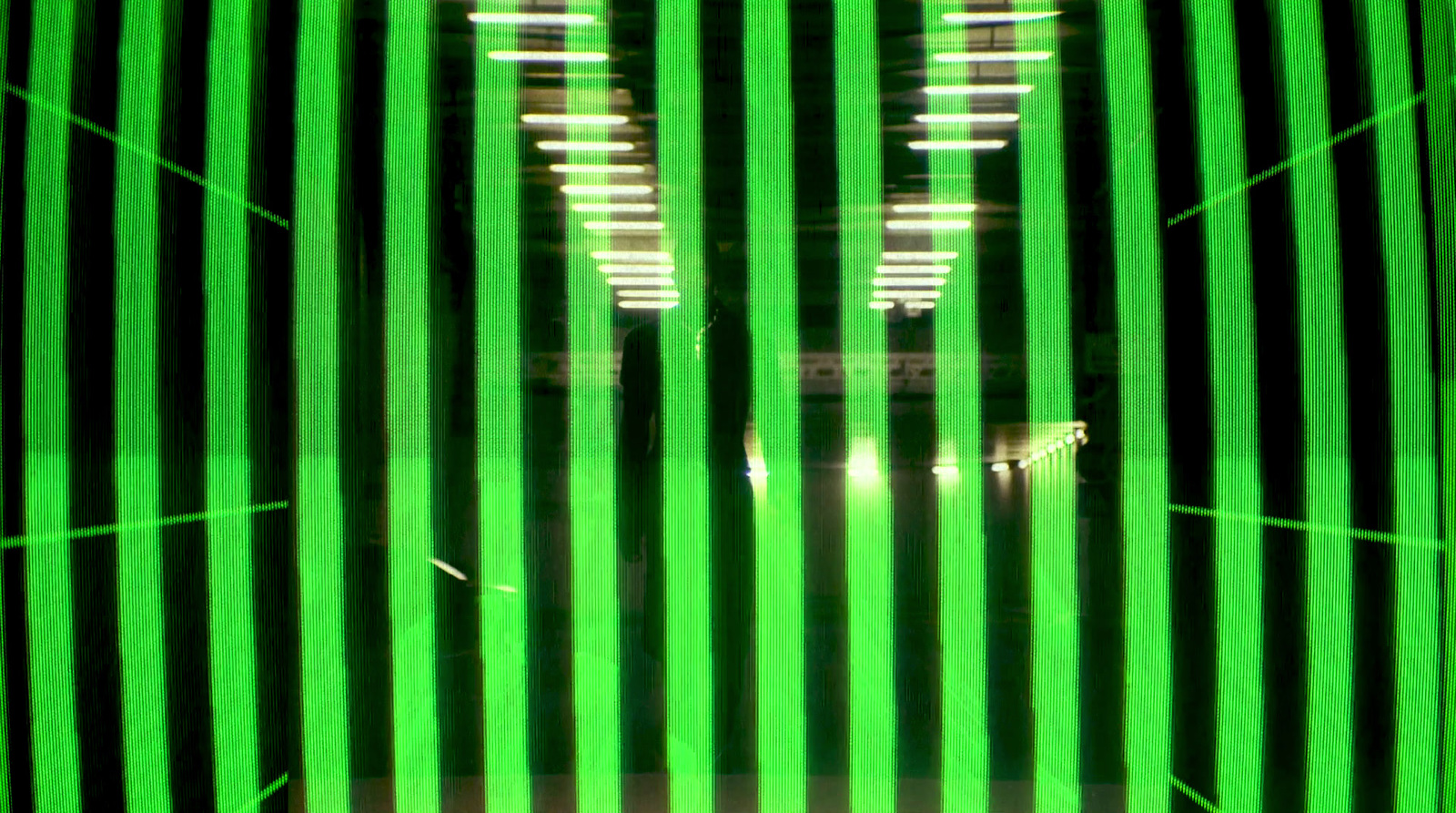 a green and black striped wall with lights