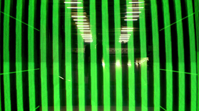 a green and black striped wall with lights