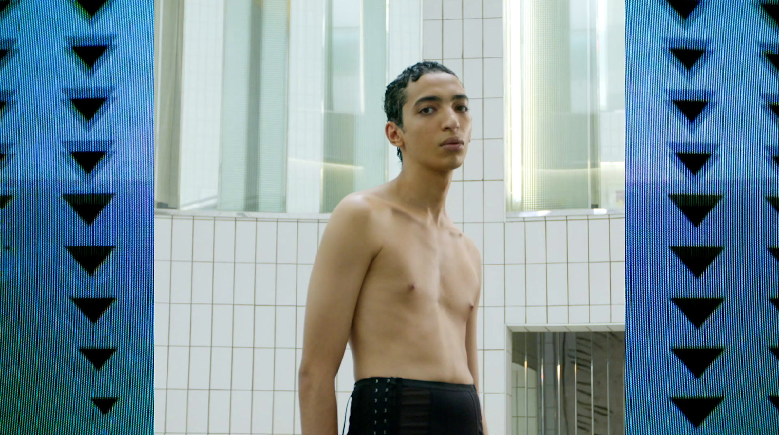 a man standing in front of a mirror in a bathroom