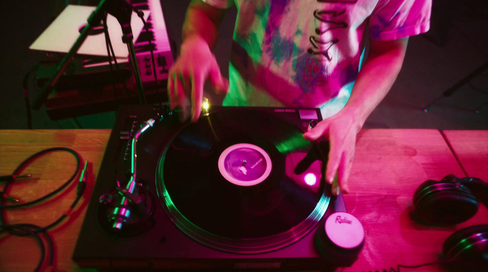 a man standing next to a record player