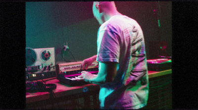 a man standing in front of a mixing desk