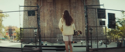 a woman is standing in front of a stage