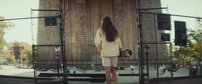 a woman is standing in front of a stage